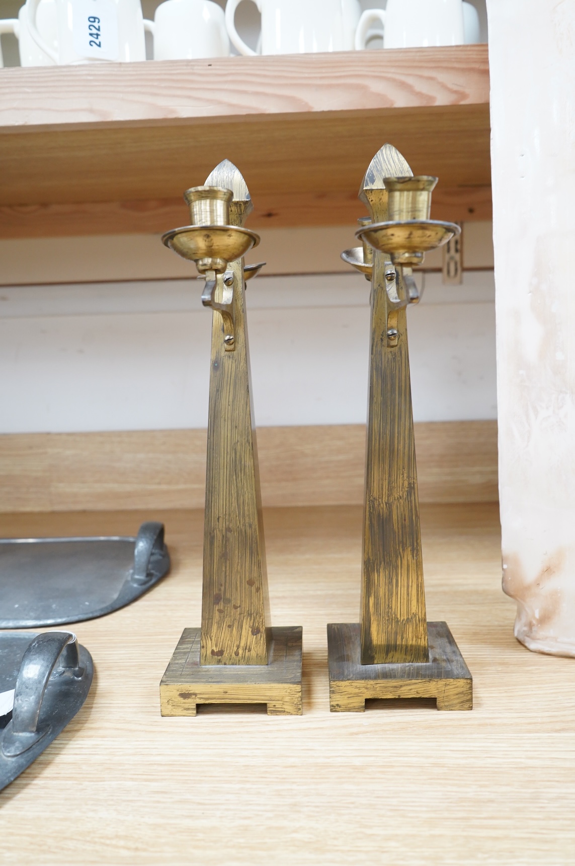 A pair of Jugendstil Arts and Crafts brass two branch candelabra, 37cm high